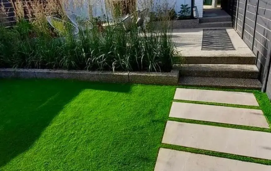 Pristine artificial turf installation in a backyard, offering a green lawn year-round.